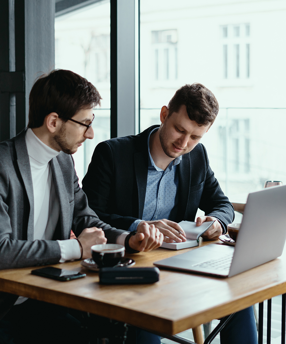 Two young businessman having a successful meeting at restaurant.